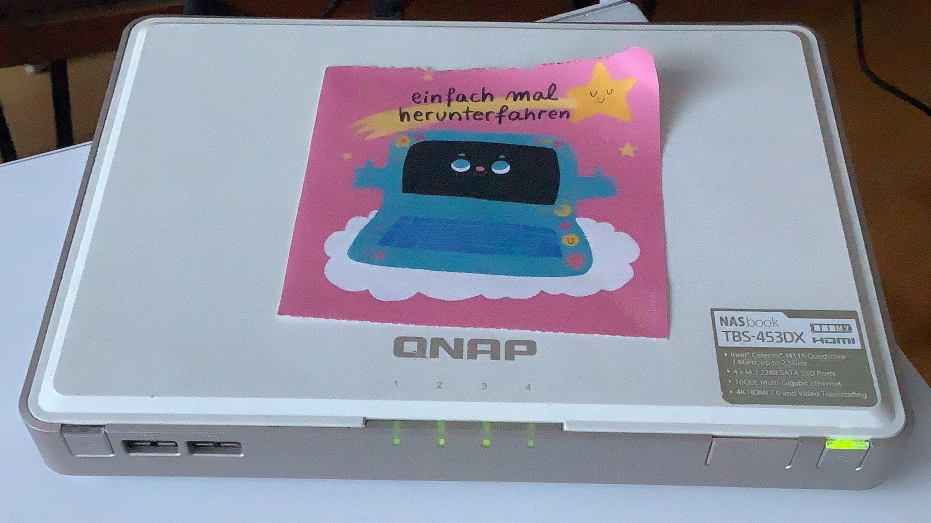 A photo of my NAS with a comic on it that says "einfach mal herunterfahren". Roughly translated: just shut it off.